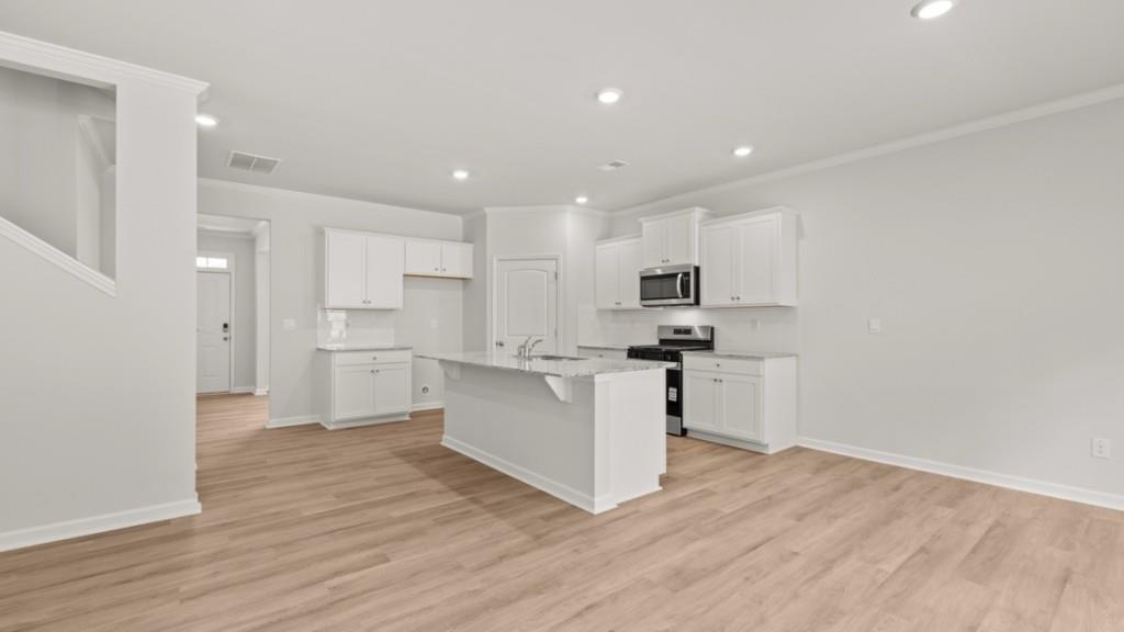 6008 Muirfield Point Union City, GA 30213 - Photo 5 of 29 a kitchen with white cabinets and stainless steel appliances
