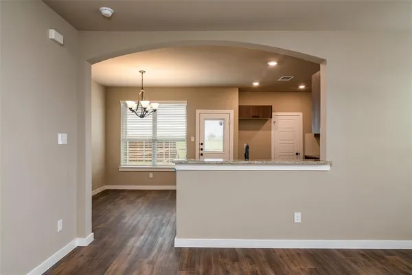 an open room with wooden floor and windows