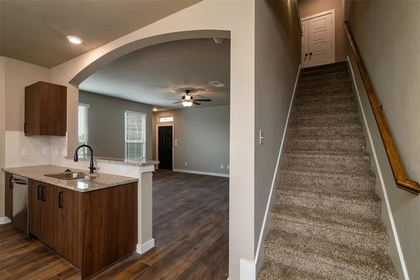 a kitchen with sink and mirror