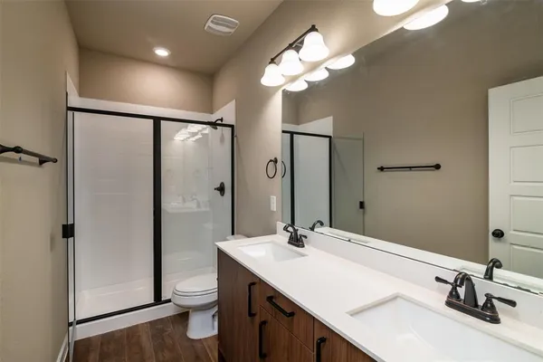 a bathroom with a sink toilet and shower
