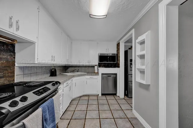 a kitchen with a stove a refrigerator and a sink