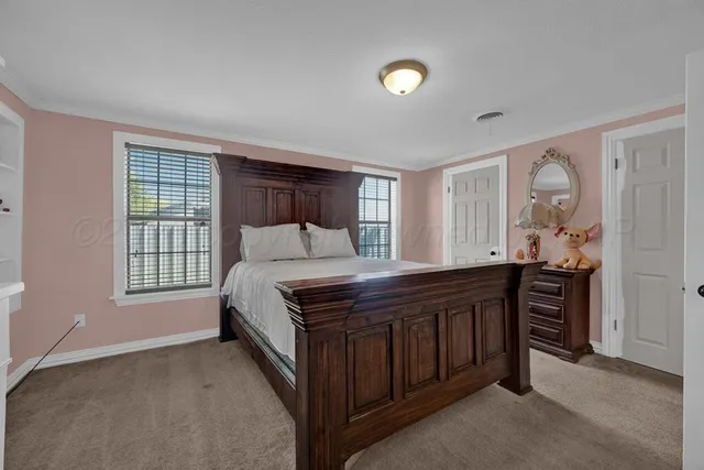 a bed sitting in a bedroom next to a window