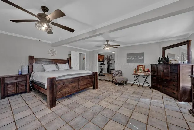 a bedroom with bed and a chandelier