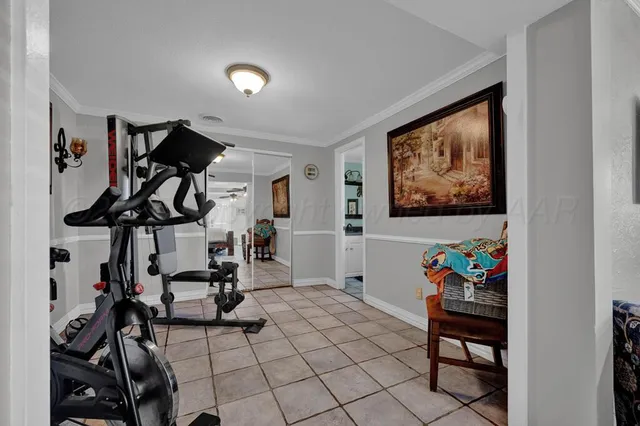 a view of a livingroom with furniture and gym equipment