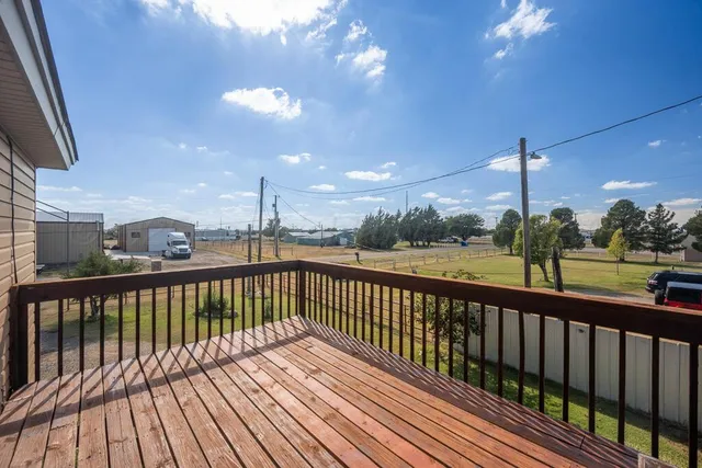 a view of a balcony with wooden floor