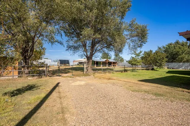 a view of yard with swimming pool and green space
