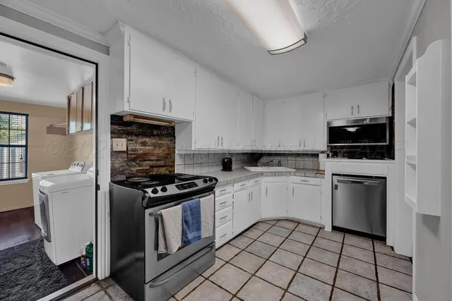 a kitchen with a stove and a microwave