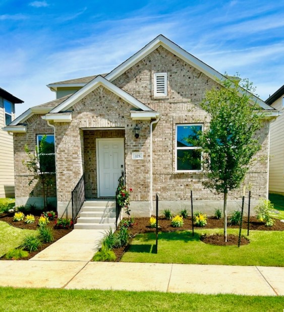 125 Watkinville Road Hutto, TX 78634 - Photo 2 of 17 a front view of a house with a yard