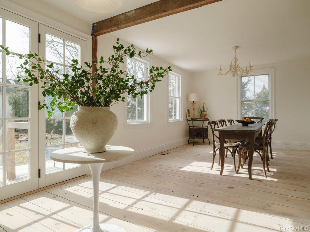 7220 Main Road East Marion, NY 11939 - Photo 17 of 44 a view of a dining room with furniture and a potted plant
