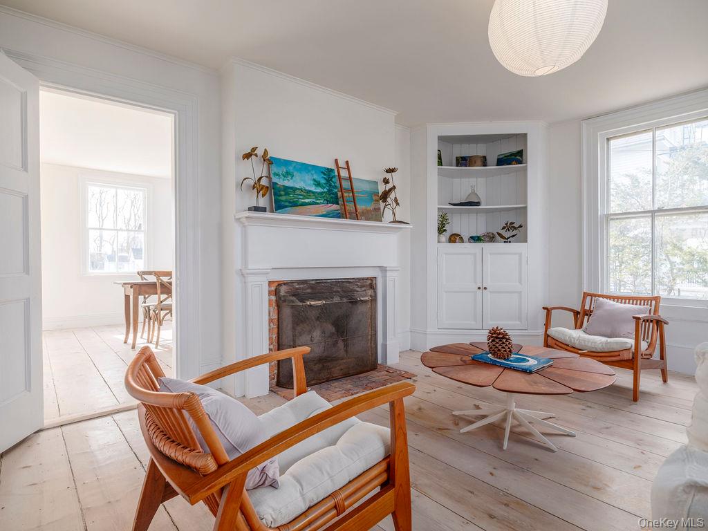 7220 Main Road East Marion, NY 11939 - Photo 22 of 44 a living room with furniture and a fireplace