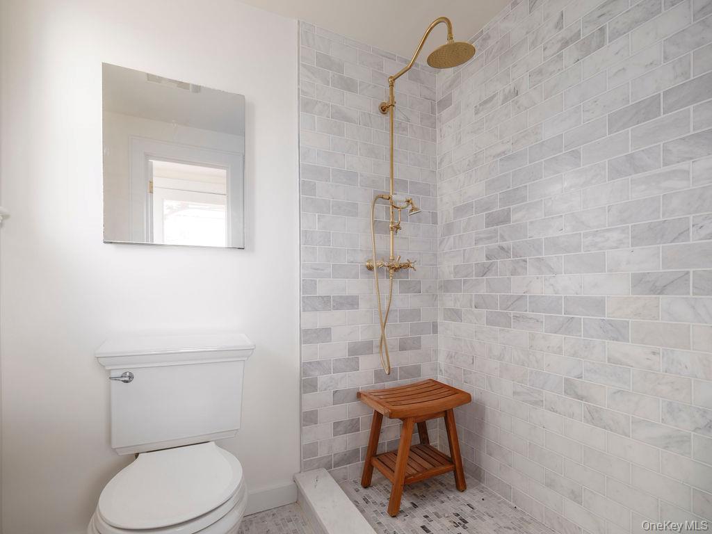 7220 Main Road East Marion, NY 11939 - Photo 26 of 44 a white toilet sitting next to a shower