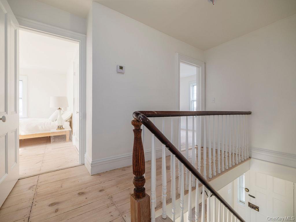 7220 Main Road East Marion, NY 11939 - Photo 28 of 44 a view of a hallway view with wooden floor and staircase