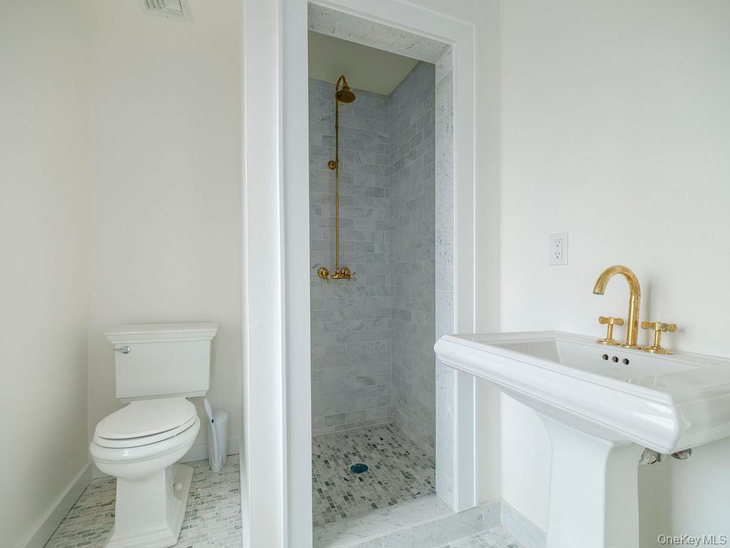 7220 Main Road East Marion, NY 11939 - Photo 34 of 44 a bathroom with a sink a toilet and shower