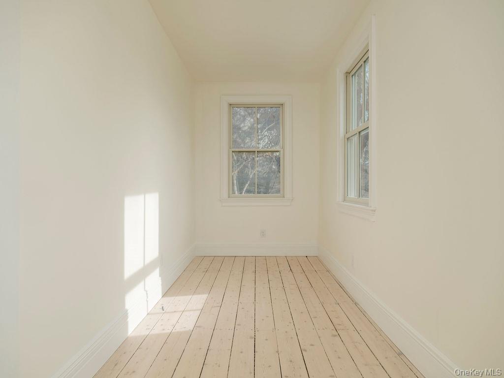 7220 Main Road East Marion, NY 11939 - Photo 36 of 44 an empty room with wooden floor and windows