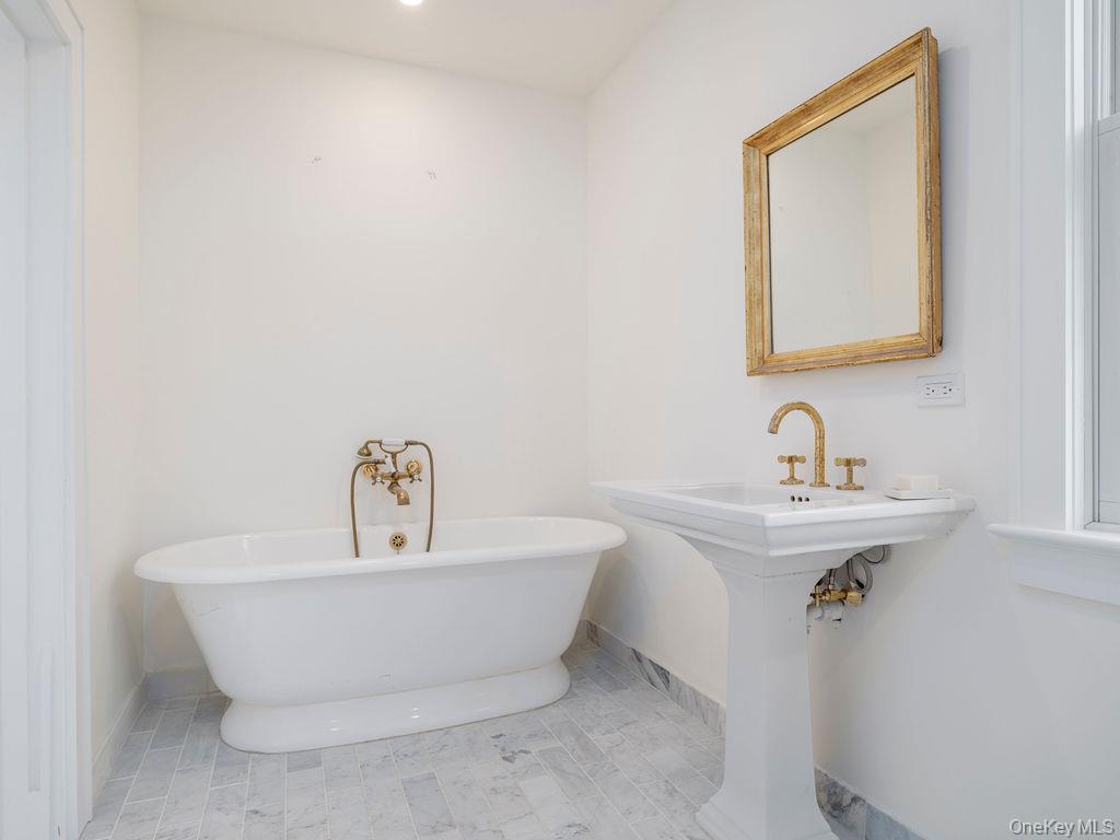 7220 Main Road East Marion, NY 11939 - Photo 38 of 44 a white bath tub sitting next to a white sink