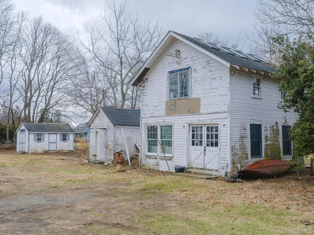 7220 Main Road East Marion, NY 11939 - Photo 42 of 44 a view of a house with a yard and large tree