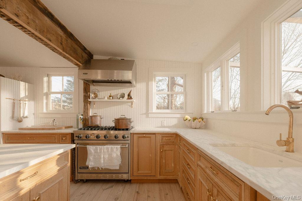 7220 Main Road East Marion, NY 11939 - Photo 7 of 44 a kitchen with stainless steel appliances granite countertop a sink stove and cabinets