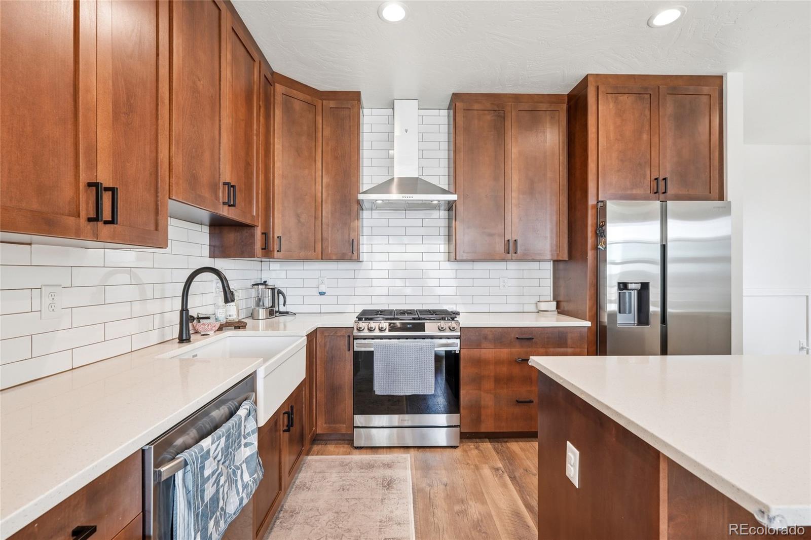 287 Dipper Court Berthoud, CO 80513 - Photo 11 of 29 a kitchen with stainless steel appliances granite countertop a sink stove and refrigerator