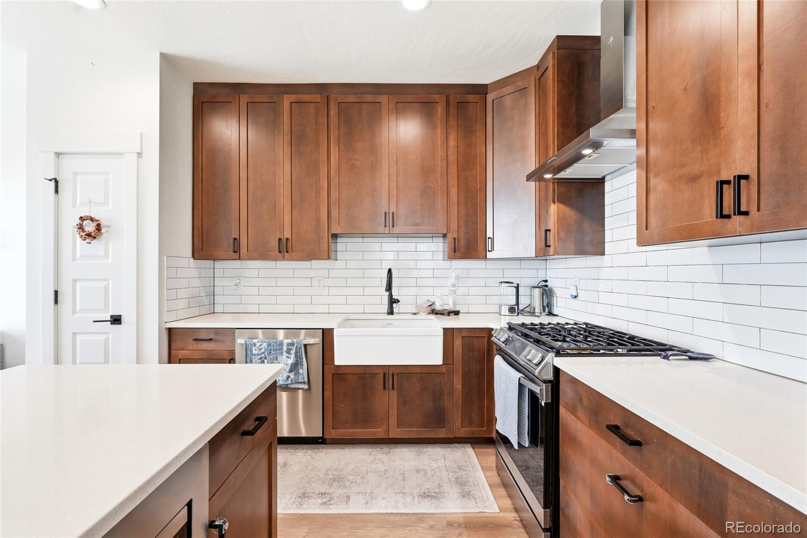 287 Dipper Court Berthoud, CO 80513 - Photo 12 of 29 a kitchen with a sink stove and cabinets