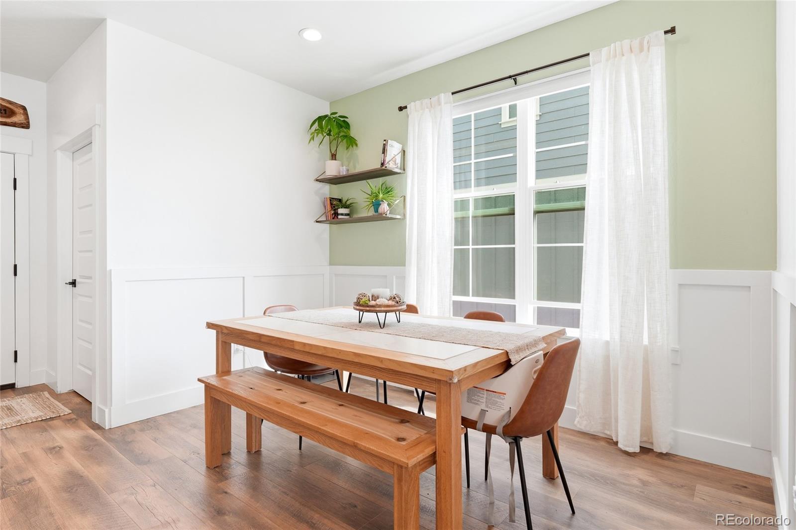 287 Dipper Court Berthoud, CO 80513 - Photo 13 of 29 a view of a dining room with furniture and wooden floor