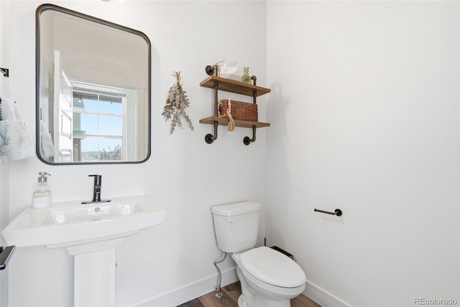 287 Dipper Court Berthoud, CO 80513 - Photo 16 of 29 a bathroom with a toilet a sink and mirror