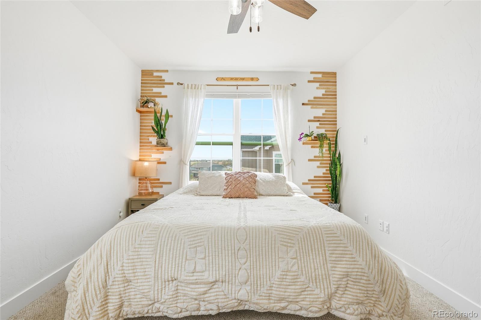 287 Dipper Court Berthoud, CO 80513 - Photo 19 of 29 a bedroom with a bed and wooden floor