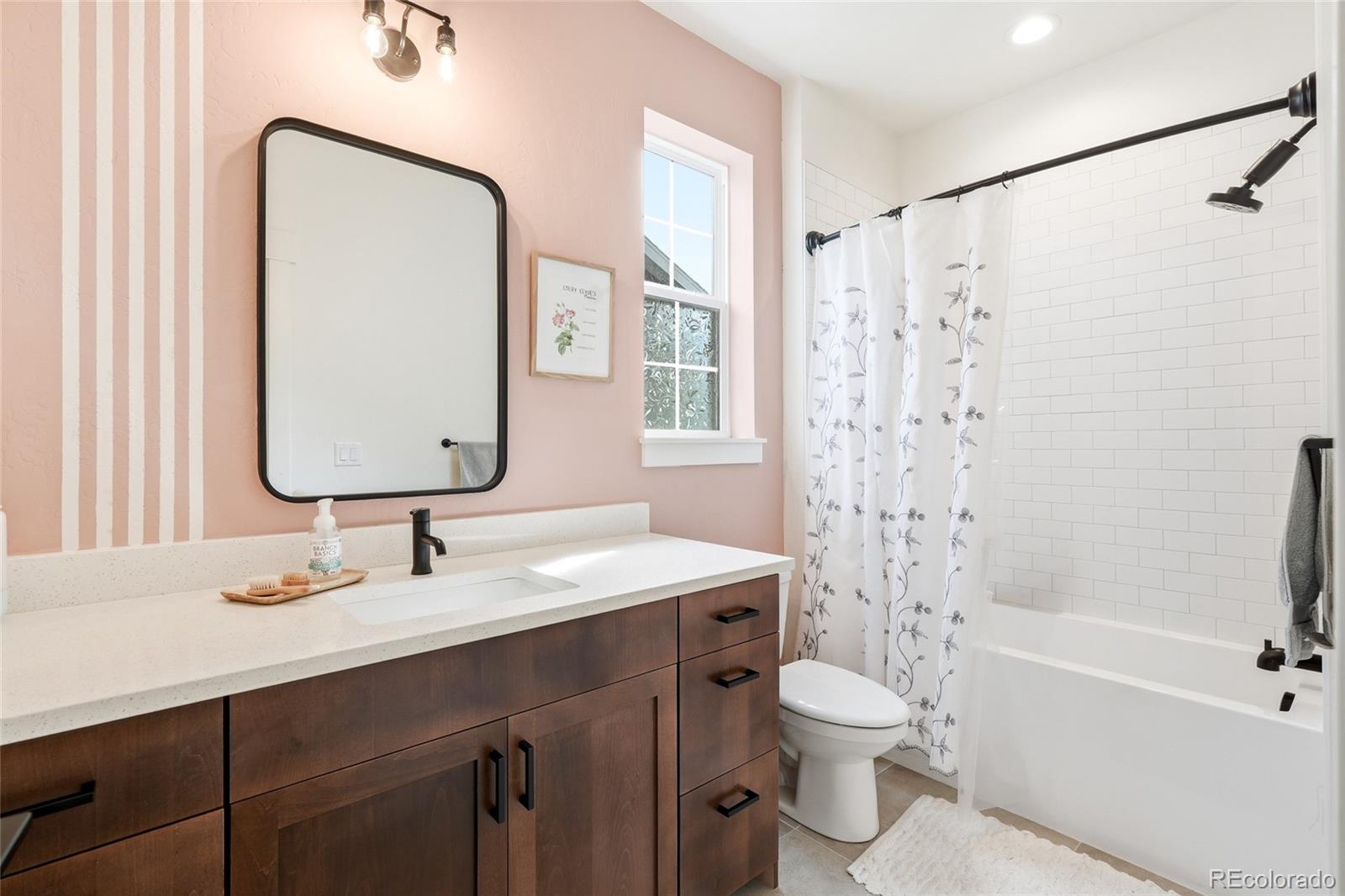 287 Dipper Court Berthoud, CO 80513 - Photo 24 of 29 a bathroom with a double vanity sink toilet mirror and shower
