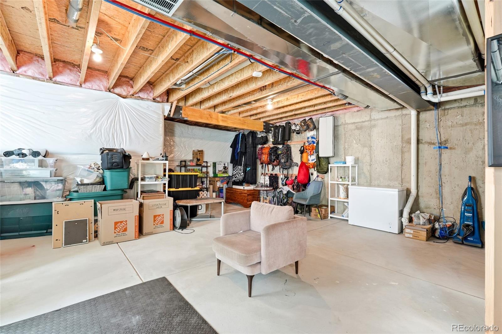 287 Dipper Court Berthoud, CO 80513 - Photo 27 of 29 a living room with furniture and a chandelier