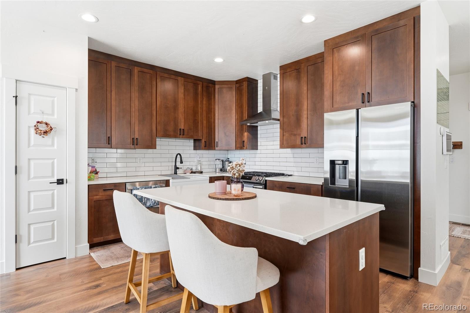 287 Dipper Court Berthoud, CO 80513 - Photo 8 of 29 a kitchen with a dining table chairs and refrigerator
