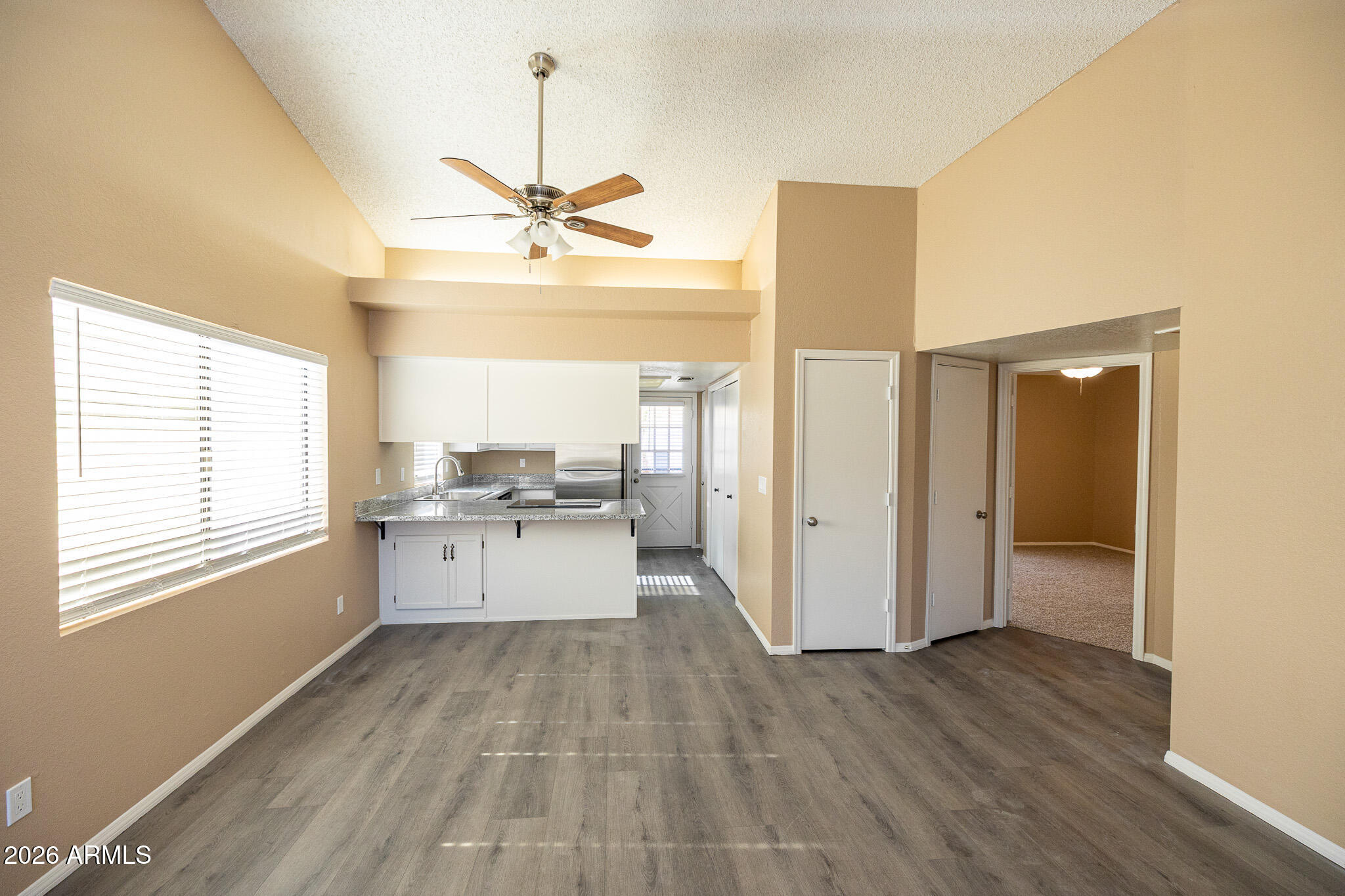 542 South Higley Road, Unit 104 Mesa, AZ 85206 - Photo 11 of 22 a large white kitchen with a window and refrigerator