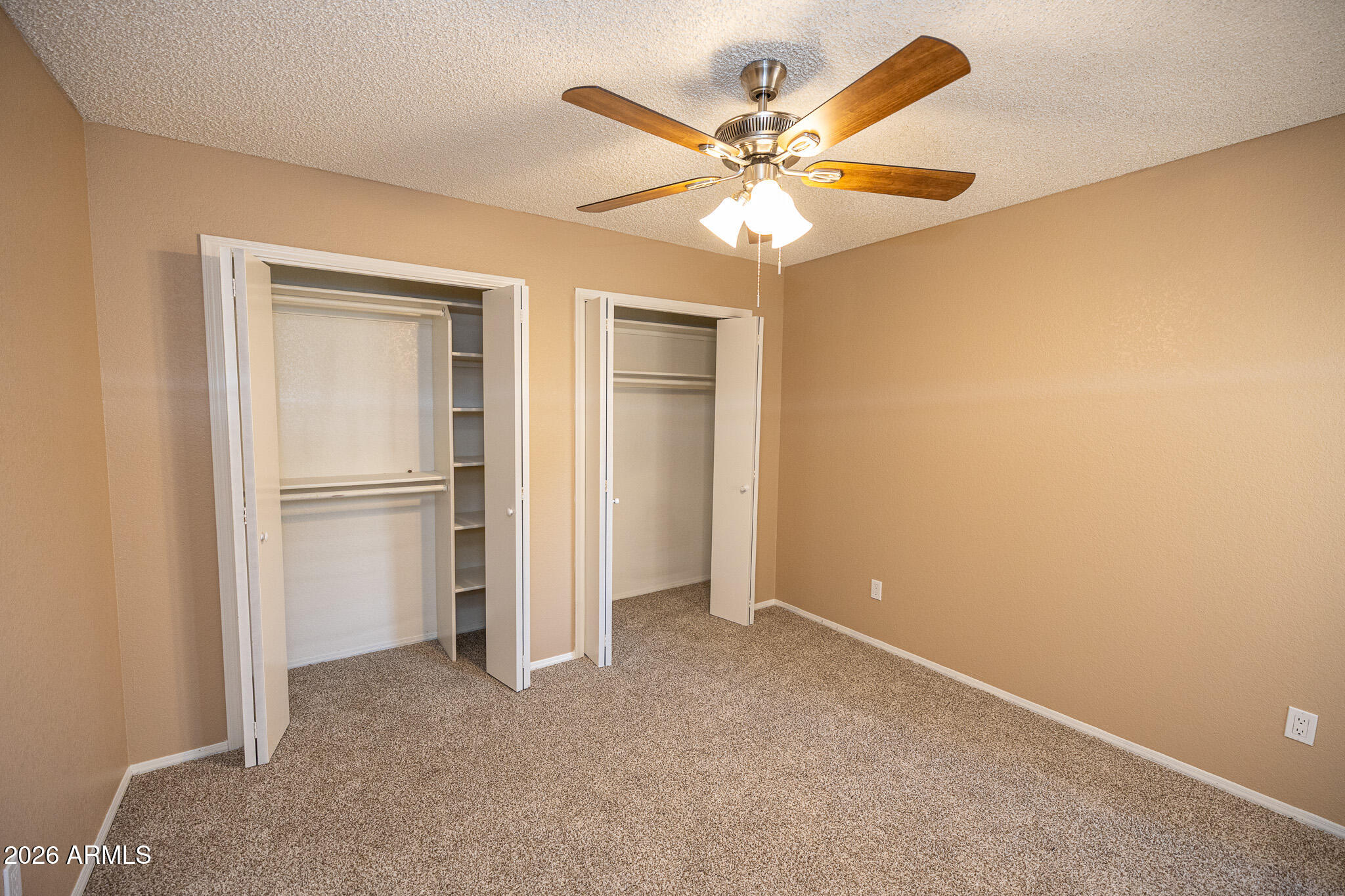 542 South Higley Road, Unit 104 Mesa, AZ 85206 - Photo 16 of 22 a view of an empty room with a ceiling fan