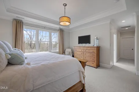 a spacious bedroom with a bed and a window