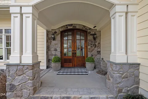 a living room with furniture large window and wooden floor