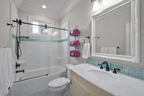 an aerial view of a house with a garden and trees