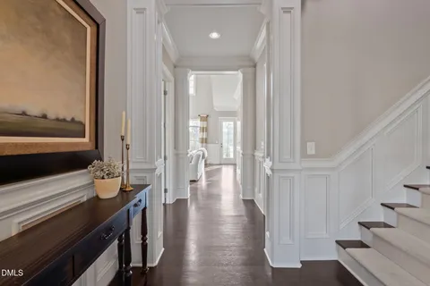 a living room with furniture a flat screen tv and a floor to ceiling window