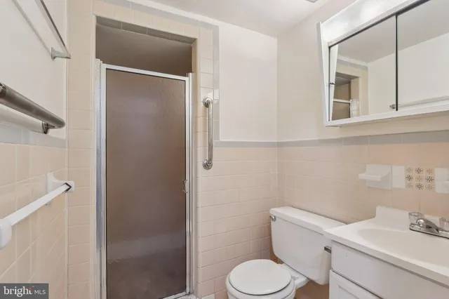 a white toilet sitting next to a bathroom sink