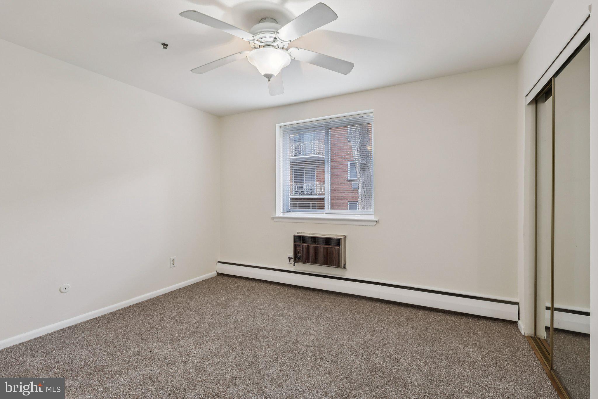 1600 Church Road, Unit C111 Wyncote, PA 19095 - Photo 14 of 24 an empty room with a ceiling fan and windows