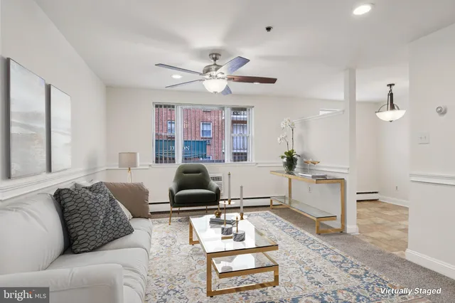a living room with furniture a rug and a chandelier