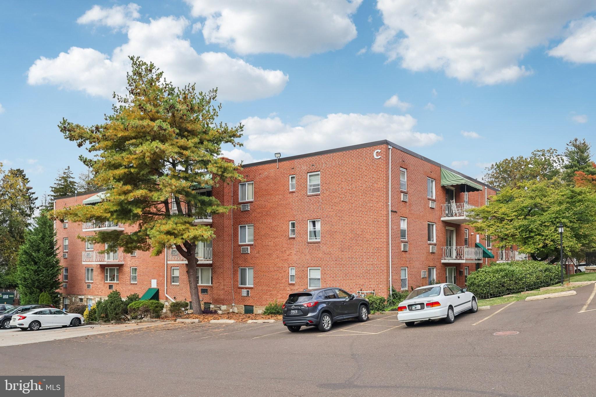 1600 Church Road, Unit C111 Wyncote, PA 19095 - Photo 23 of 24 a car parked in front of a building with parked cars