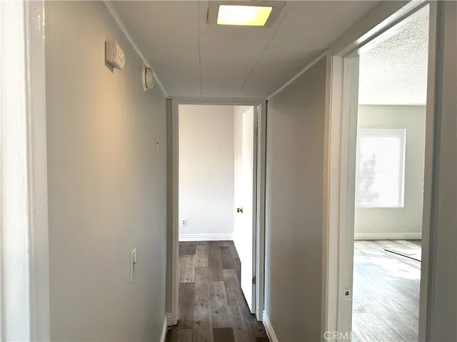a view of a room with wooden floor and windows