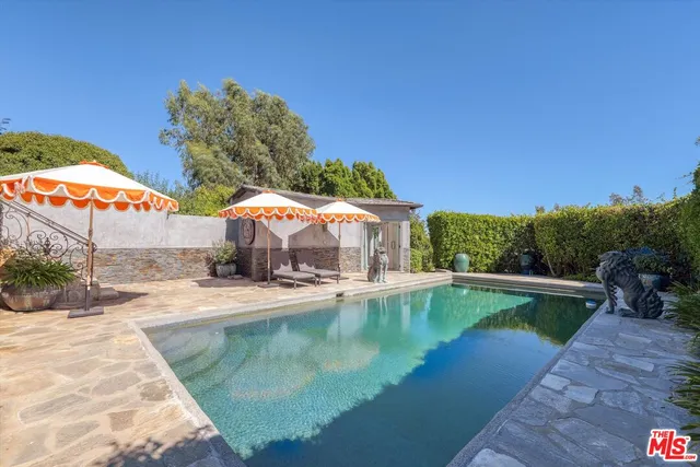 a view of a water pond with green yard