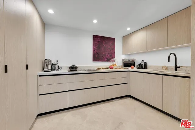 a kitchen with a sink and cabinets