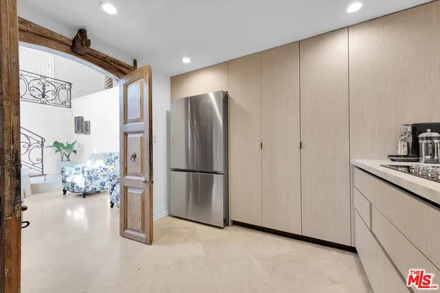 a kitchen with stainless steel appliances a refrigerator and a stove top oven