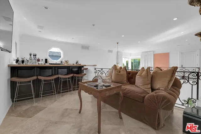 a living room with furniture kitchen view and a table