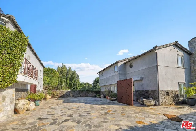 a view of a house with a snow in the background