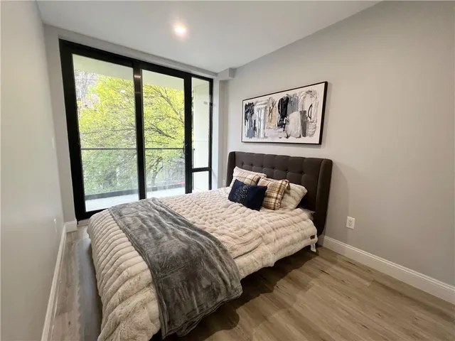 a bedroom with a large bed and a large window