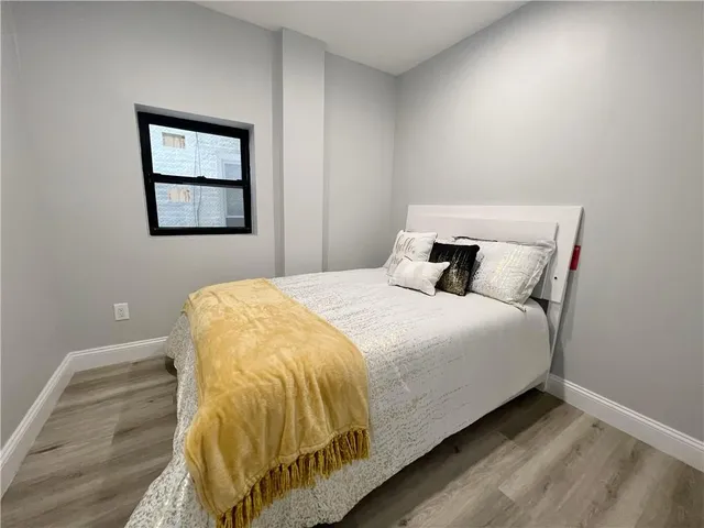 a bedroom with a bed and window