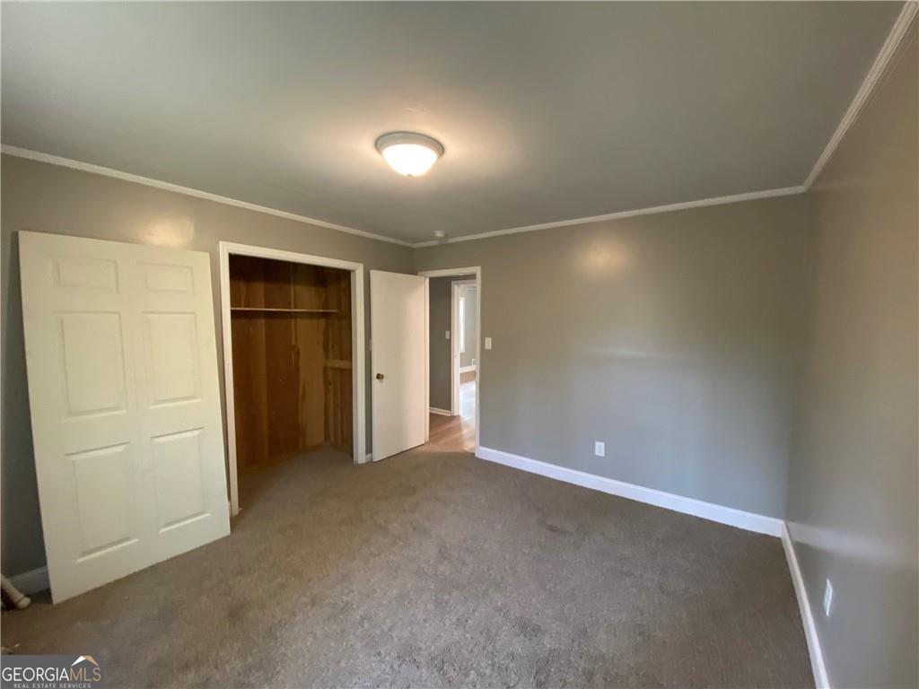 4029 Winding Way Macon, GA 31204 - Photo 11 of 24 an empty room with closet and mirror