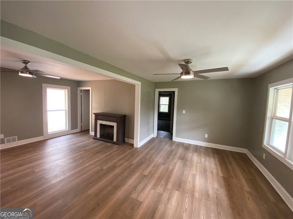 4029 Winding Way Macon, GA 31204 - Photo 14 of 24 an empty room with wooden floor fireplace and windows