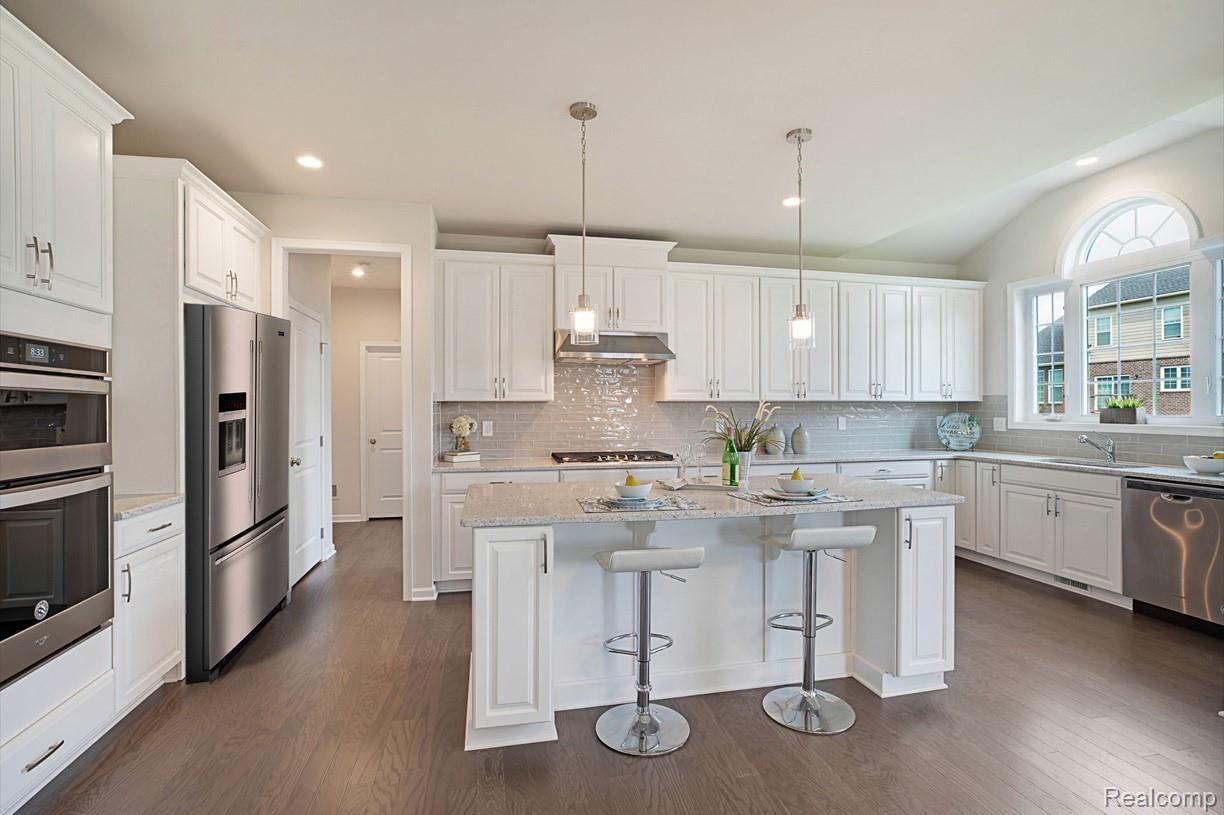 50396 Amberwood Road Canton, MI 48188 - Photo 3 of 15 Well-appointed kitchen includes Whirlpool® stainless steel appliances, Kohler® faucets, 42-inch wall cabinets, granite countertops, ceramic tile backsplash, and more